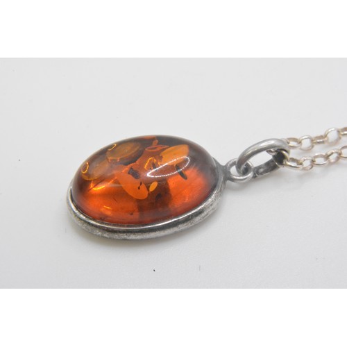 240 - 925, Italy, Silver necklace with two amber pendants one oval shaped, other graduating ambers on an 1... 