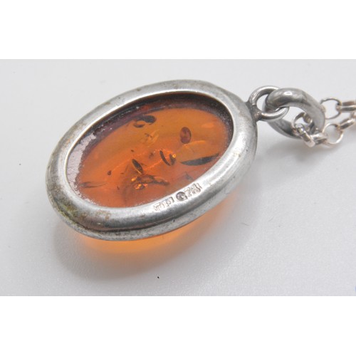 240 - 925, Italy, Silver necklace with two amber pendants one oval shaped, other graduating ambers on an 1... 