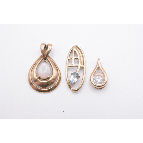 249 - x3 9ct gold pendants varying in design, featuring opal, aquamarine and clear stones. All marked 375/... 