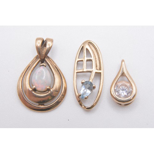 249 - x3 9ct gold pendants varying in design, featuring opal, aquamarine and clear stones. All marked 375/... 