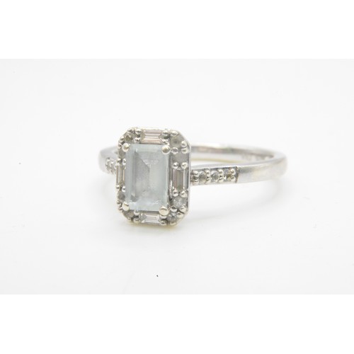 255 - White gold ring, round and rectangle cut diamonds surrounding the central baguette cut stone, diamon... 