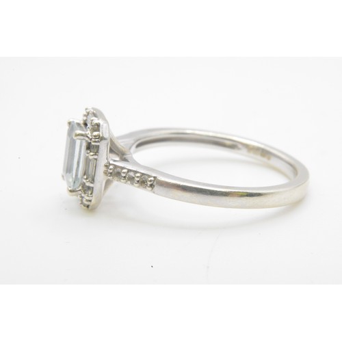 255 - White gold ring, round and rectangle cut diamonds surrounding the central baguette cut stone, diamon... 