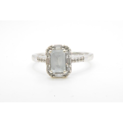 255 - White gold ring, round and rectangle cut diamonds surrounding the central baguette cut stone, diamon... 