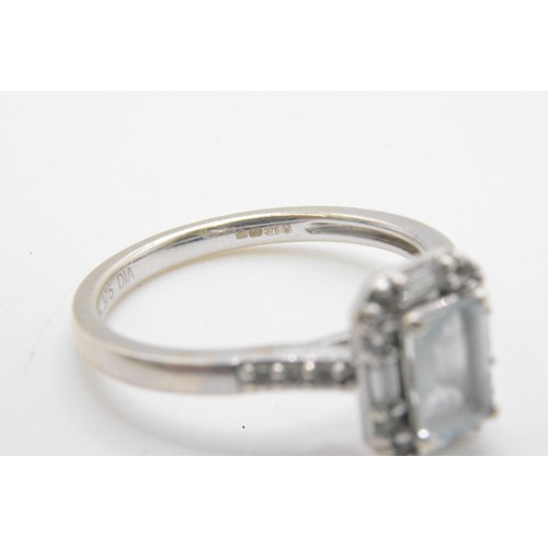 255 - White gold ring, round and rectangle cut diamonds surrounding the central baguette cut stone, diamon... 