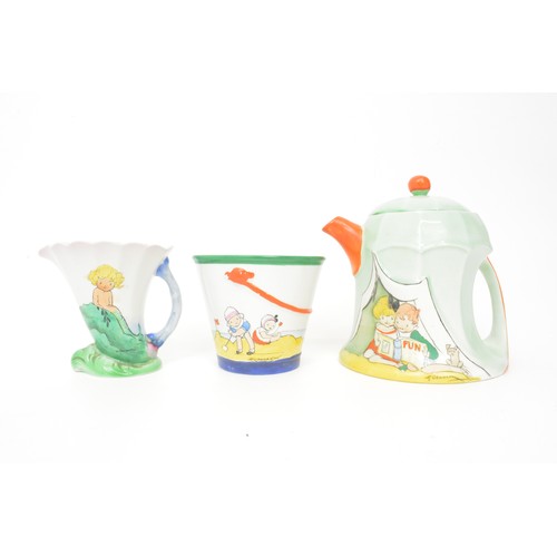 Art Deco c1930 Shelley 3 piece  'Beach Tent' Teaset by Hilda Cowham comprising teapot in the form of a tent, milk jug in the form of a seashell, sugar bowl as beach bucket each with seaside illustrations of children at play- makers mark to base and Rd.no.726181