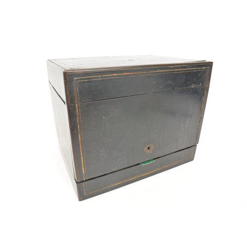 7 - Antique Liqueur Tantalus, ebonised wooden case which opens up to reveal sixteen glasses and  four ca... 