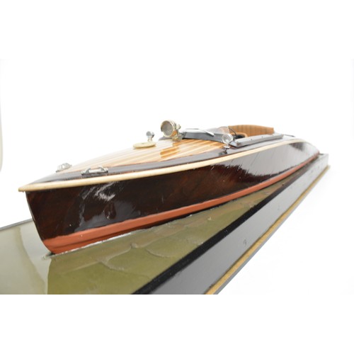 9 - Large model of motorboat, mixed composition of woods, leather seats, with glazed over case. Approx s... 