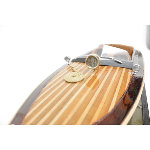 9 - Large model of motorboat, mixed composition of woods, leather seats, with glazed over case. Approx s... 