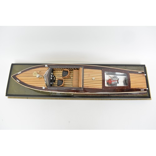 9 - Large model of motorboat, mixed composition of woods, leather seats, with glazed over case. Approx s... 
