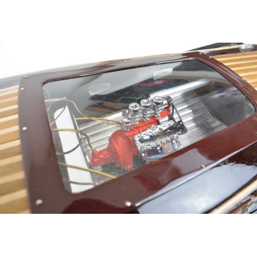 9 - Large model of motorboat, mixed composition of woods, leather seats, with glazed over case. Approx s... 