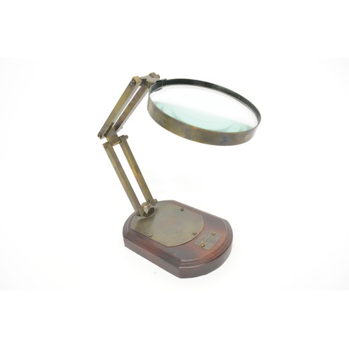 15 - Desktop magnifying glass with adjustable metal mount, bears label 'Watkins & Hill Opticians, London ... 