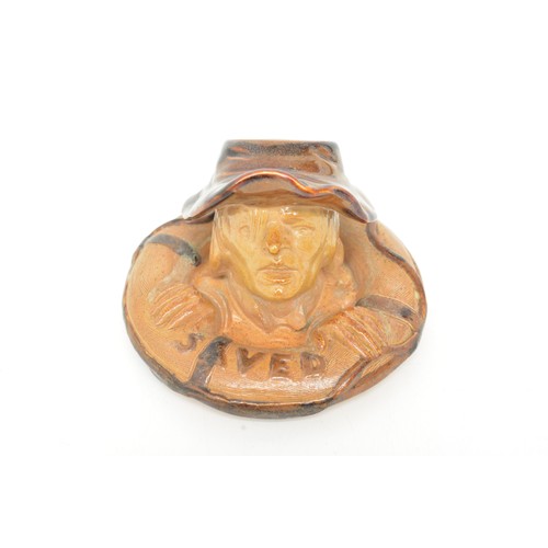 33 - A Doulton Lambeth stoneware match stand, Lifebuoy, circa 1894, modelled as a mans head and ring, mar... 