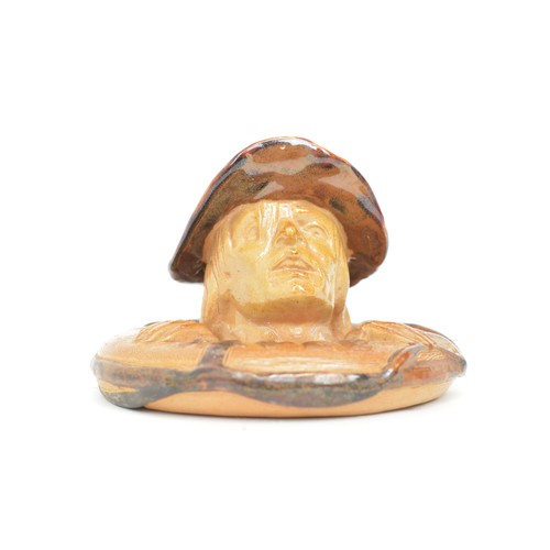 33 - A Doulton Lambeth stoneware match stand, Lifebuoy, circa 1894, modelled as a mans head and ring, mar... 