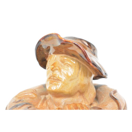 33 - A Doulton Lambeth stoneware match stand, Lifebuoy, circa 1894, modelled as a mans head and ring, mar... 