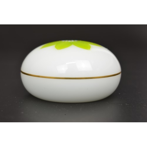 52 - Saint Louis Crystal, France - A white opaline  paperweight  with a zesty green flower petal bloom