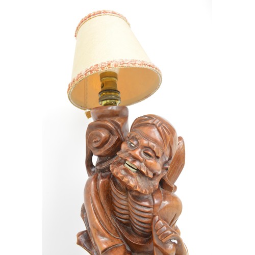 59 - A pair of oriental lamps, carved form of elder holding staff. Untested AF.