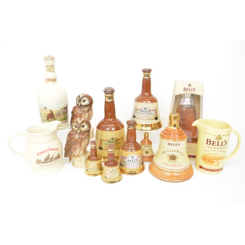 117 - A large collection of Wade ceramic Scotch Whisky decanters - Bells and Famous Grouse.  Plus Whyte an... 