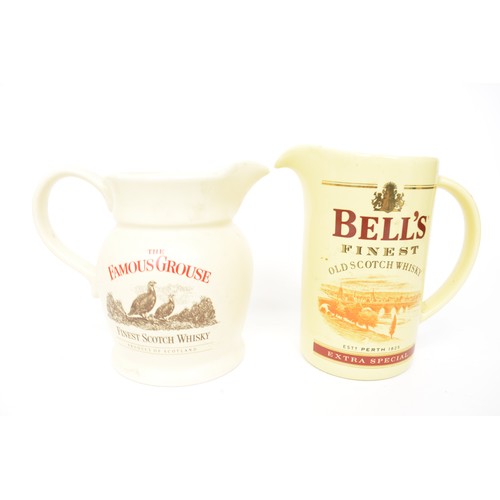 117 - A large collection of Wade ceramic Scotch Whisky decanters - Bells and Famous Grouse.  Plus Whyte an... 