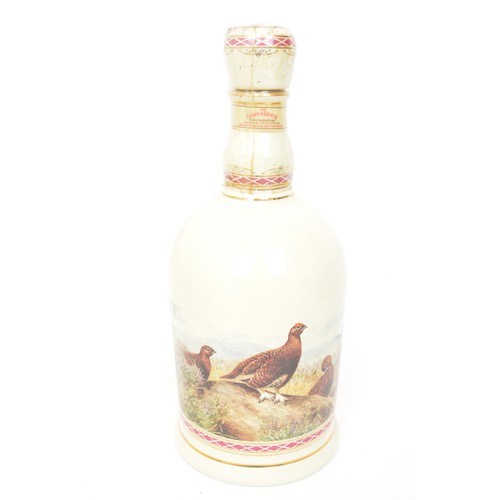 117 - A large collection of Wade ceramic Scotch Whisky decanters - Bells and Famous Grouse.  Plus Whyte an... 