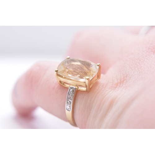 258 - 9ct yellow gold ring with golden rutilated quartz and diamonds, marked 375, approx size P