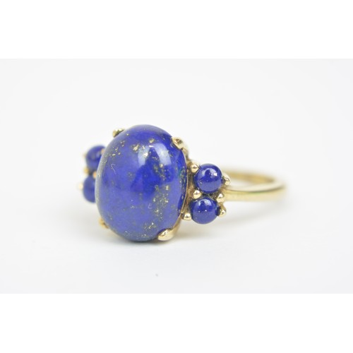 270 - Lapis Lazuli 9ct yellow gold ring, cabochon oval central stone with four round stones, approx size P... 