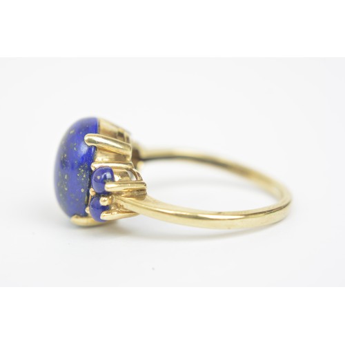 270 - Lapis Lazuli 9ct yellow gold ring, cabochon oval central stone with four round stones, approx size P... 