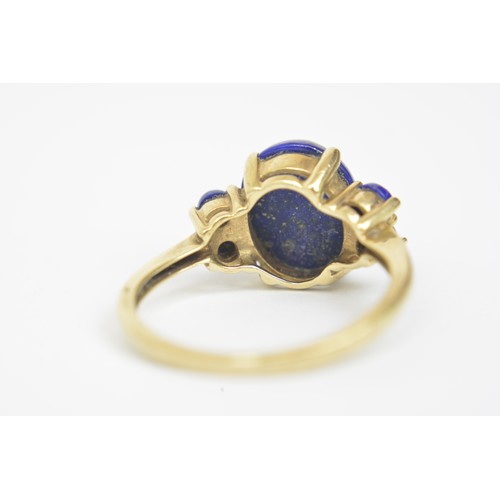 270 - Lapis Lazuli 9ct yellow gold ring, cabochon oval central stone with four round stones, approx size P... 
