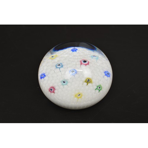 Baccarat glass paperweight, white base with millefiori to centre featuring zodiac symbols, marked Baccarat 1974 to base