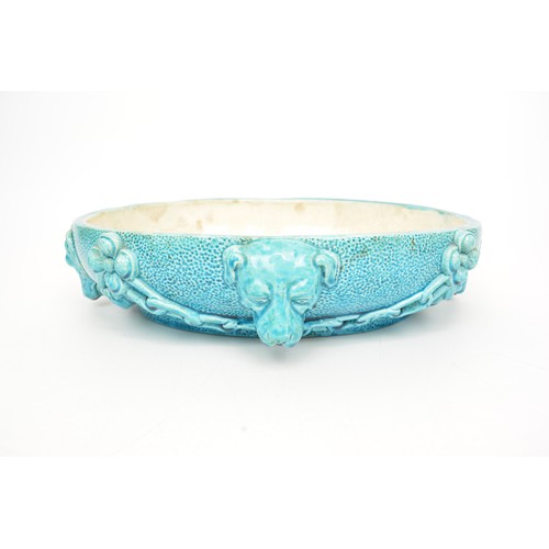 Burmantofts faience 1592 centrepiece bowl with four moulded dog head decoration within a chain relief surround, L33cm, W27cm, H7.5cm.