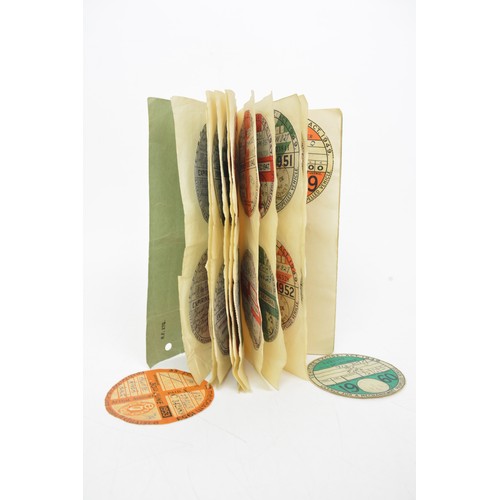 A book containing Specimen Annual Road Tax Discs dating 1921-1960 (complete) together with loose discs incl. Irish and international, plus collector's book and fuel ration books.