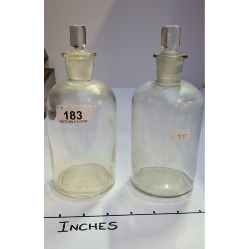 183 - Two antique chemist bottles one with a chipped rim.