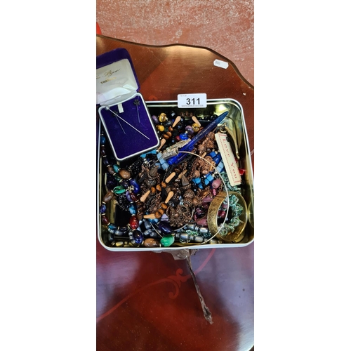 311 - Biscuit tin box full of costume Jewellery.