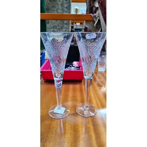 320 - Pair of tall Waterford crystal Champagen flutes Heavy good order.