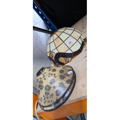 337 - Three small leopard print shades and a glass Tiffany style shade.