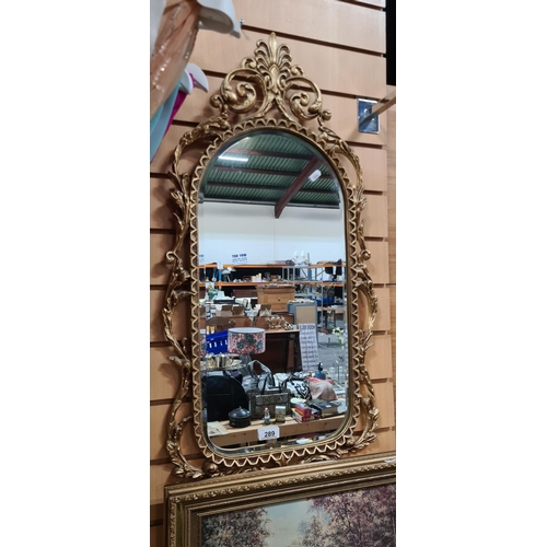 289 - Heavy Gilt brass bevelled oval mirror. 90cm long.