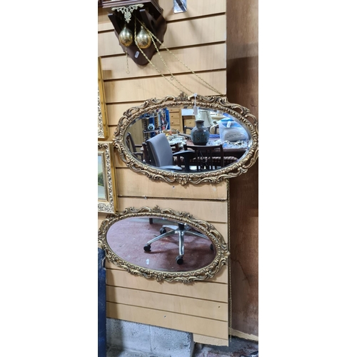 308 - Two oval gilt bevelled mirrors can be hung landscape or portrait