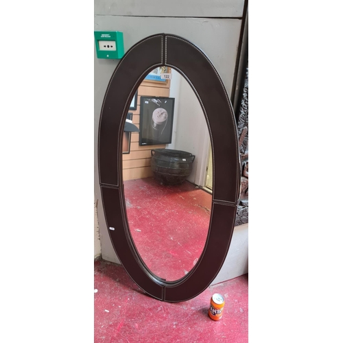 122 - Large Oval Leather mirror. 60cm wide by 120cm tall aprrox