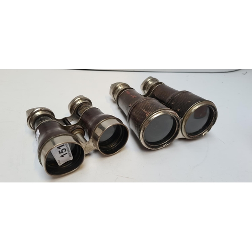 151 - Two pair of Antique Military binoculars. With leather grips.