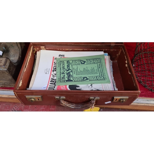 191 - Brown leather small suitcase full of Sheet music inc irish items.