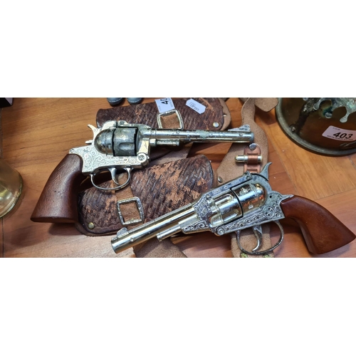 402 - Two Cap guns with a gun belt.