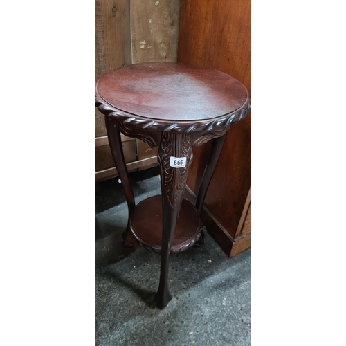 666 - Mahogany plant table with pie crust edge.