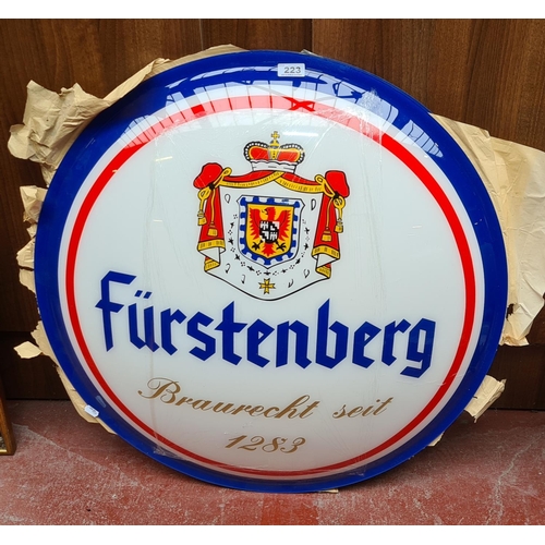 223 - Large Furstenberg back and front beer signs.