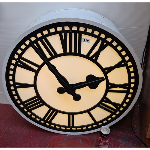 119 - Huge light up Wall clock. Plugs in. 77cm wide by 25cm deep. Very impressive clock.