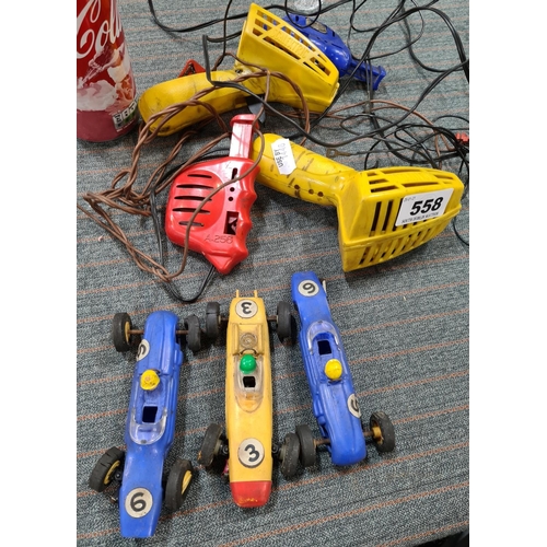 558 - Three vintage Scaletrix cars and 4 vintage controllers.