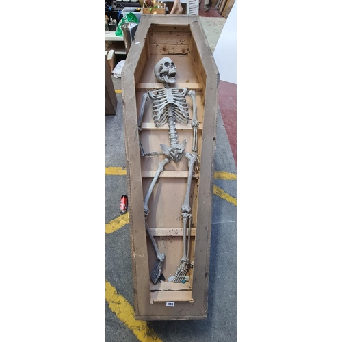 83 - Wooden coffin with a full  faux skeleton, 184cm x 63cm x 30cm tall.