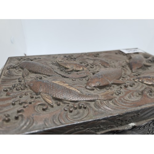 304 - Antique bronze Chinese box with fish in relief.