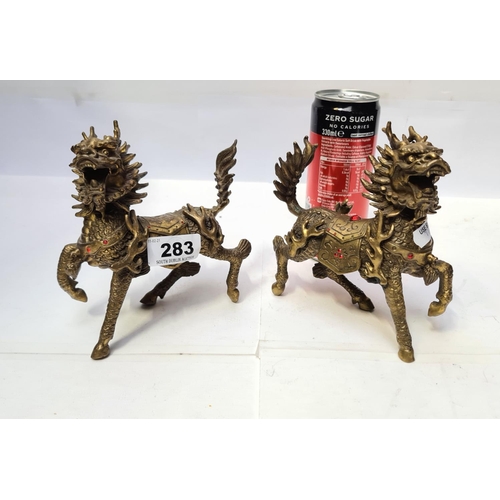 283 - Two heavy brass Chinese dragons.