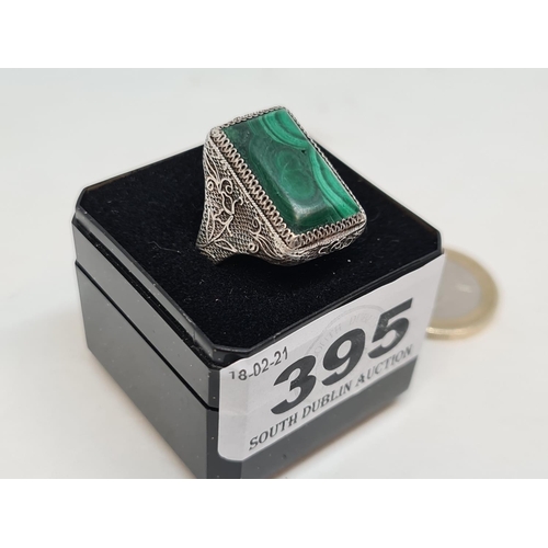 395 - Sterling silver ring with lovey work and malachite stone.