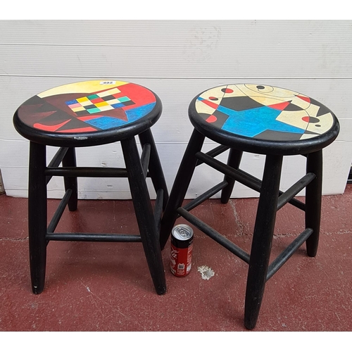 492 - Two black stools with funky tops.