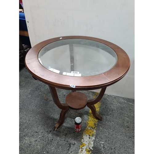 549 - Small round coffee table with glass top. Nice design